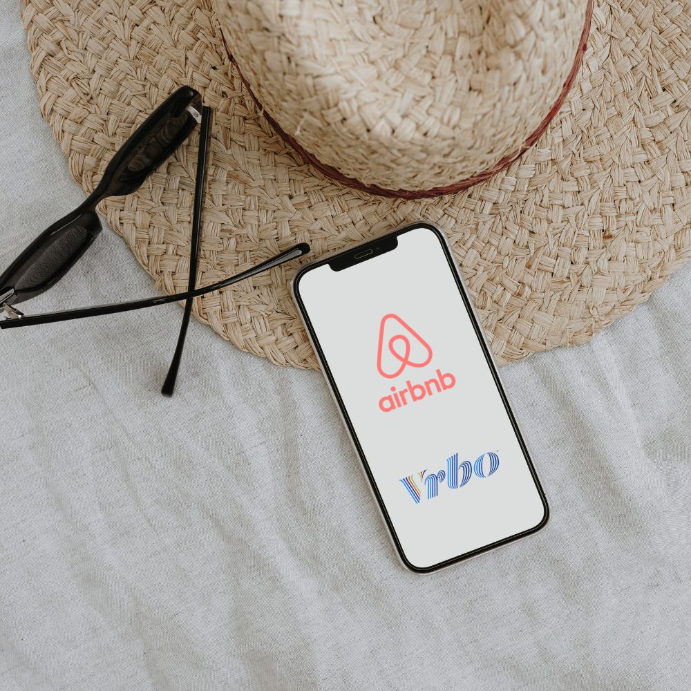Phone showing Airbnb and VRBO apps